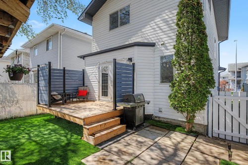 Exterior wood deck featuring privacy screening, a multi-pane glass door, and a three-step entry - 16211 55A Street, Edmonton, AB - Outdoor With Deck Patio Veranda With Exterior
