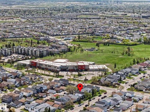 Aerial perspective of a residential neighborhood with detached homes, featuring tree-lined streets and a prominent green space - 16211 55A Street, Edmonton, AB - Outdoor With View
