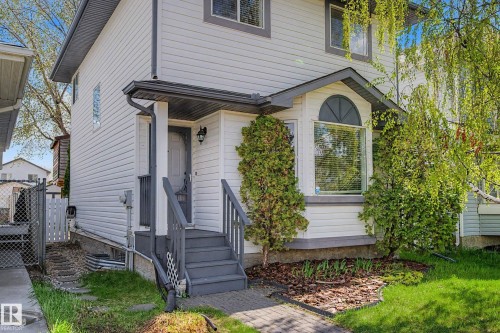 Two-story home with white siding and gray trim accents - 16211 55A Street, Edmonton, AB - Outdoor