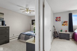Carpeted interior spaces with light-colored walls and baseboard heating - 