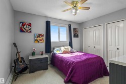 Bedroom featuring light gray walls and a window with dark curtains - 