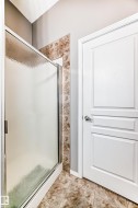 Enclosed shower with textured glass and polished chrome framing - 