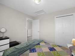 Neutral wall paint with white trim, a flush-mount ceiling light fixture, bi-fold closet doors, and an additional white paneled door - 