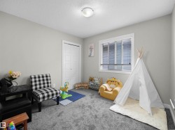 Light gray wall paint, recessed window with blinds, and durable gray carpeting - 