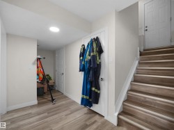 Wood-finish flooring throughout, complemented by a prominent staircase with matching wood-finish treads - 