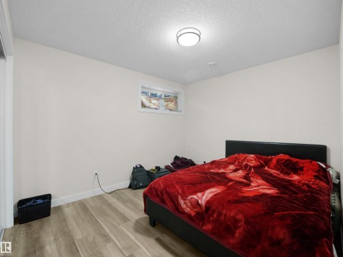 Room featuring light-toned walls and wood-finish flooring - 3247 15 Avenue Nw, Edmonton, AB 