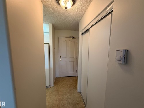 Entryway featuring a white paneled door, ceramic tile flooring, and a flush mount ceiling light - 424 16303 95 Street, Edmonton, AB - Indoor Photo Showing Other Room