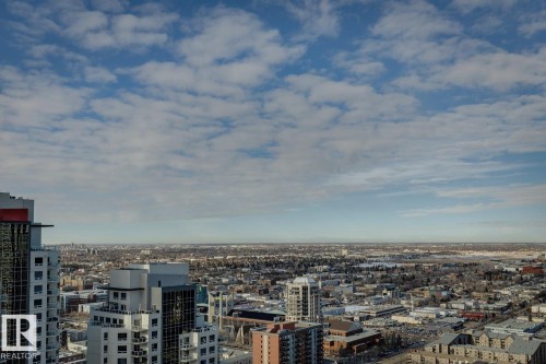 Expansive skyline showcasing distant mountain ranges and urban architecture - 3302 10180 103 Street, Edmonton, AB - Outdoor With View