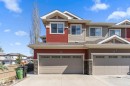 Multi-level exterior featuring red and beige siding with stone accents - 23 3103 Hilton Drive, Edmonton, AB  - Outdoor With Facade 