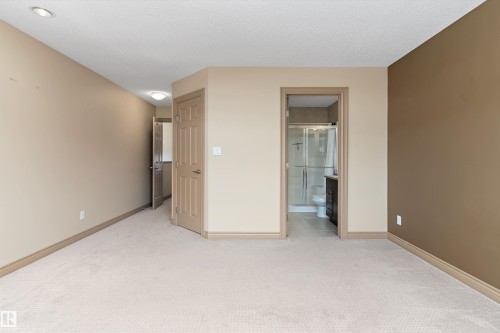 Spacious room featuring neutral carpet flooring and a neutral color palette on the walls - 23 3103 Hilton Drive, Edmonton, AB - Indoor Photo Showing Other Room
