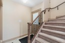 Entryway featuring a carpeted staircase with wrought iron spindles and a wood handrail - 23 3103 Hilton Drive, Edmonton, AB  - Indoor Photo Showing Other Room 