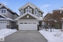 Craftsman-style house with stone siding, a garage, and concrete driveway - 1915 77 Street, Edmonton, AB  - Outdoor With Facade 