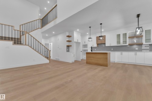 Open-concept living space featuring light wood-finish flooring - 6226 45 Avenue, Beaumont, AB - Indoor Photo Showing Kitchen