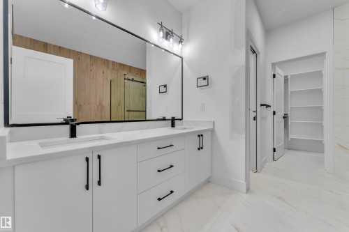Dual vanity with white cabinetry, matte black hardware, and integrated sinks - 6226 45 Avenue, Beaumont, AB - Indoor