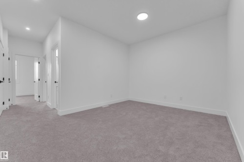 Spacious room with light gray carpeting and white painted walls - 6226 45 Avenue, Beaumont, AB - Indoor Photo Showing Other Room