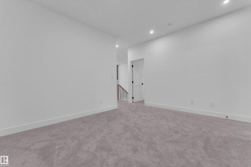 Spacious interior room with light gray carpeting, recessed ceiling lighting, and crisp white walls - 6226 45 Avenue, Beaumont, AB - Indoor Photo Showing Other Room