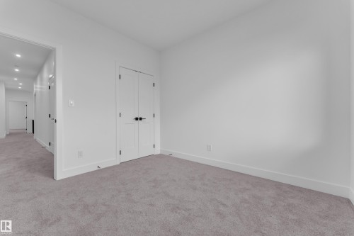 Plush grey carpeting and bright white walls create a clean aesthetic - 6226 45 Avenue, Beaumont, AB - Indoor Photo Showing Other Room