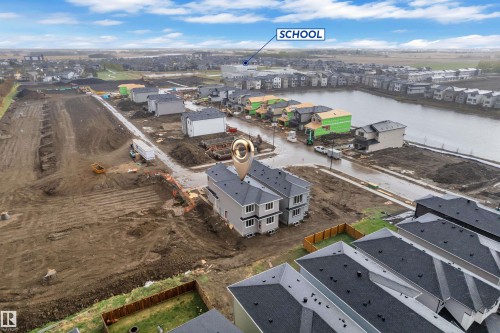 Newly constructed townhomes featuring contemporary siding, multi-level design, and individual fenced yards - 6226 45 Avenue, Beaumont, AB - Outdoor With View