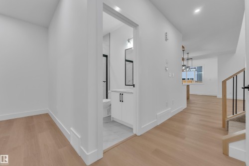 Bright interior hallway with light wood-finish flooring - 6226 45 Avenue, Beaumont, AB - Indoor Photo Showing Other Room