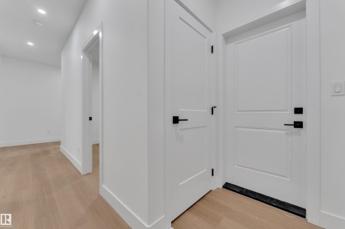 Hallway featuring light wood-finish flooring, recessed lighting, and crisp white walls - 6226 45 Avenue, Beaumont, AB - Indoor Photo Showing Other Room
