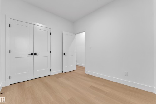 Bright interior space featuring light wood-finish flooring - 6226 45 Avenue, Beaumont, AB - Indoor Photo Showing Other Room