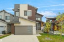 Contemporary residence featuring a multi-textured facade with horizontal siding and stone accents - 162 Edgewater Circle, Leduc, AB  - Outdoor 