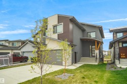 Contemporary exterior featuring a combination of stucco, wood-look siding, and stone accents - 