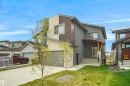 Contemporary exterior featuring a combination of stucco, wood-look siding, and stone accents - 162 Edgewater Circle, Leduc, AB  - Outdoor 