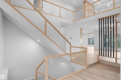Multi-level interior featuring a glass and wood-finish staircase - 