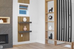 Corner architectural feature wall with light wood-finish vertical slats, a built-in window, and two floating shelves - 
