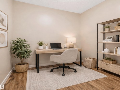 This room features light-toned walls, wood-style flooring, and a windowless design - 120 8931 156 Street, Edmonton, AB - Indoor Photo Showing Office