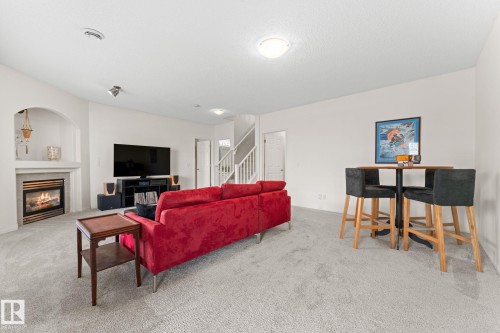 6 10848 8 Avenue, Edmonton, AB - Indoor Photo Showing Living Room With Fireplace