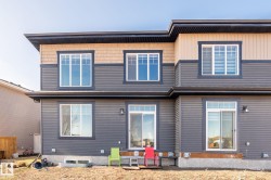 Two-story exterior featuring dark gray horizontal siding and upper-level beige shingle accents - 