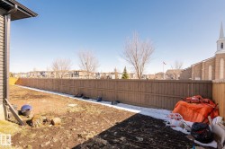 Spacious backyard with a wood privacy fence outlining the perimeter - 