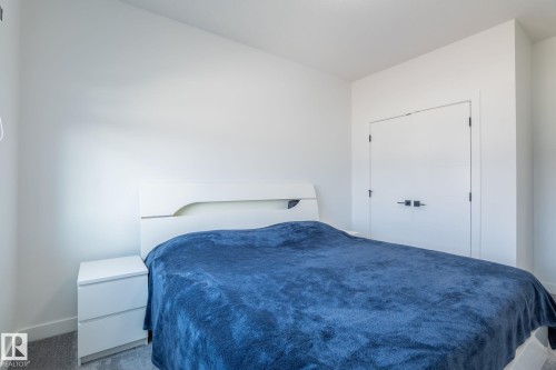 White walls with a sloped ceiling and light gray carpet flooring - 6607 50A Avenue, Beaumont, AB - Indoor Photo Showing Bedroom