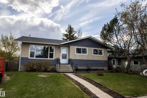 Exterior featuring stucco and horizontal siding, a gabled roof, and multiple large windows - 5125 46 Ave, St. Paul Town, AB - Outdoor With Facade