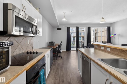 341 4827 104A Street, Edmonton, AB - Indoor Photo Showing Kitchen With Fireplace