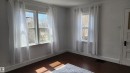 Large windows adding natural light - 5017 51 Street, Elk Point, AB  - Indoor Photo Showing Other Room 