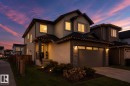 Contemporary home featuring a stucco exterior, stone facade accents, a paved driveway, a covered entry with columns, and a landscaped front yard with ground lighting - 6303 169 Avenue, Edmonton, AB  - Indoor Photo Showing Other Room 