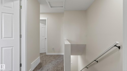 Upper-level hallway featuring neutral wall tones, white trim, and a low-pile carpet - 14125 30 Street, Edmonton, AB - Indoor Photo Showing Other Room