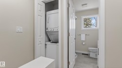 Compact laundry closet featuring a stackable washer and dryer - 