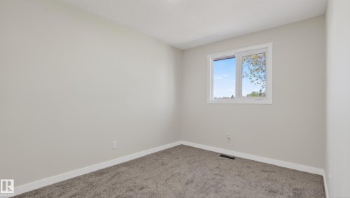 Neutral-toned room featuring a single window with white trim, light gray walls, and gray carpet flooring - 14125 30 Street, Edmonton, AB - Indoor Photo Showing Other Room