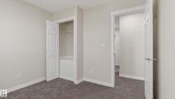 Neutral-toned walls and plush gray carpeting characterize this room - 