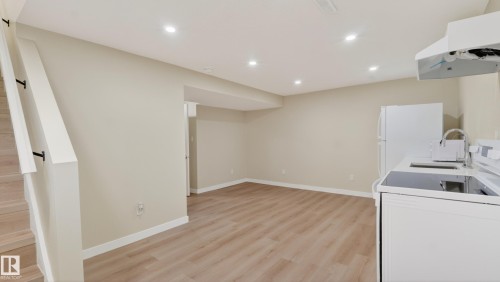 Open-concept living space featuring wood-finish flooring, recessed lighting, and a neutral color palette - 14125 30 Street, Edmonton, AB - Indoor Photo Showing Laundry Room