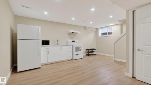 Open concept living space featuring wood-finish flooring, recessed lighting, and a neutral color palette - 14125 30 Street, Edmonton, AB - Indoor