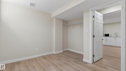 Spacious room featuring wood-finish flooring and a closet with wire shelving - 