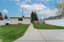 Expansive grassy yard with concrete pathway, surrounded by a white chain-link fence - 13231 74 Street, Edmonton, AB  - Outdoor 