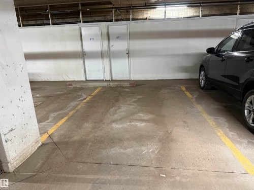 Concrete parking garage with marked parking space - 309 10610 76 Street, Edmonton, AB - Indoor Photo Showing Garage
