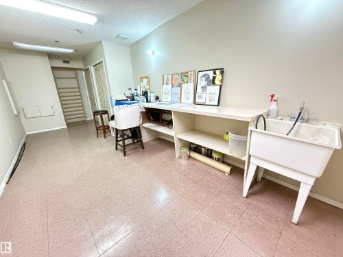 Versatile interior space featuring light-toned walls and square tile flooring - 309 10610 76 Street, Edmonton, AB - Indoor Photo Showing Office