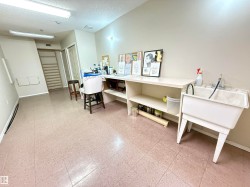 Versatile interior space featuring light-toned walls and square tile flooring - 